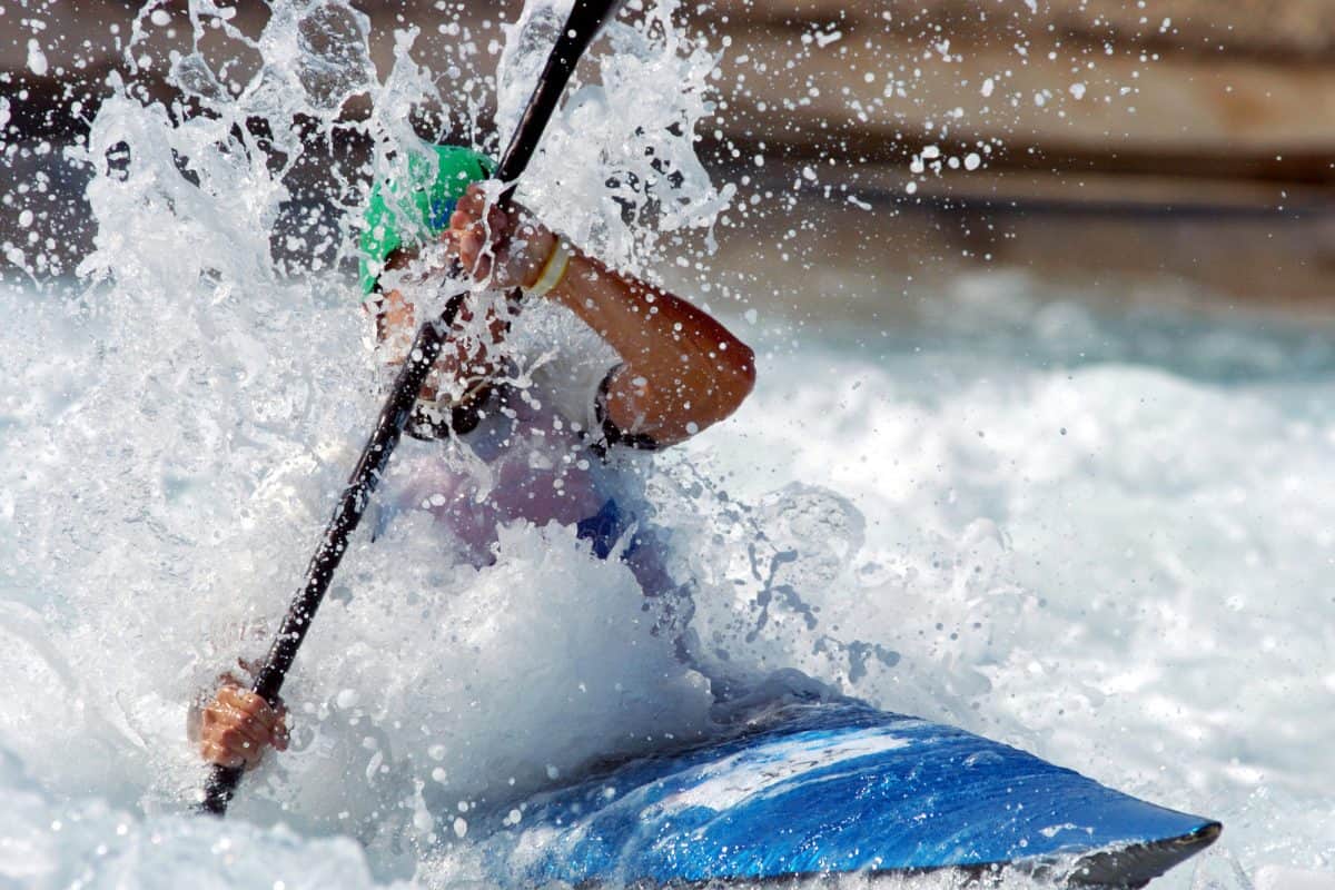 A kayaker races down the whitewater of a river.