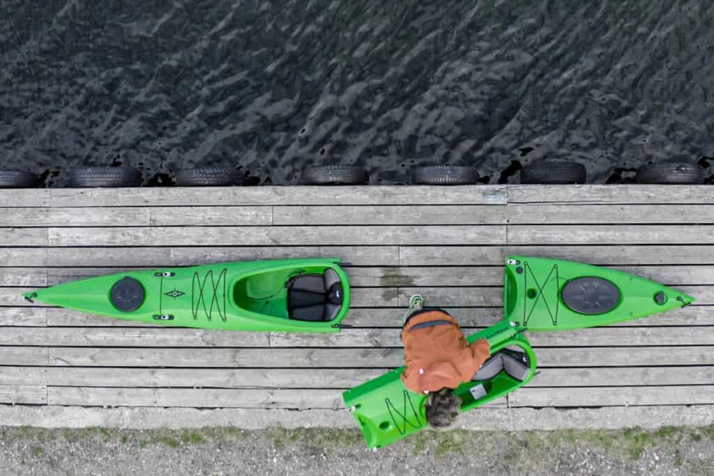 Overhead show of a man putting together a modular kayak
